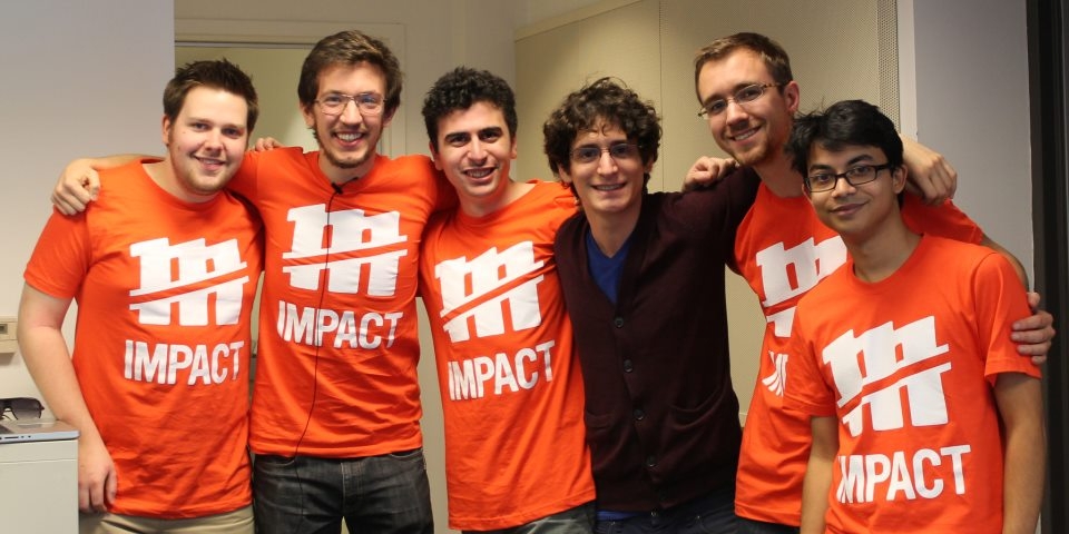 Photo of myself with the rest of the Michigan Hackers executive board at MHacks: Impact, wearing the event t-shirts